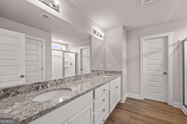 32 Joseph Ln, Hartwell, GA 30643 - full bathroom with a stall shower, double vanity, and wood finished floors