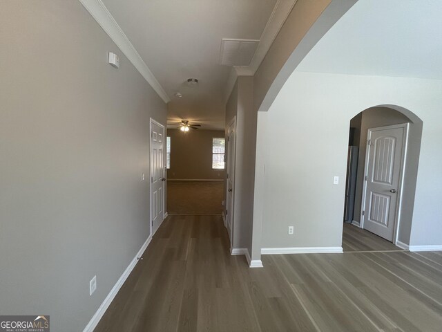 corridor with crown molding and wood-type flooring