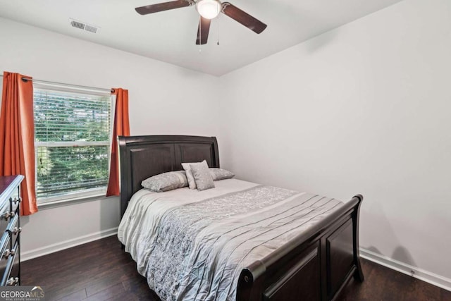 bedroom with ceiling fan and dark hardwood / wood-style flooring