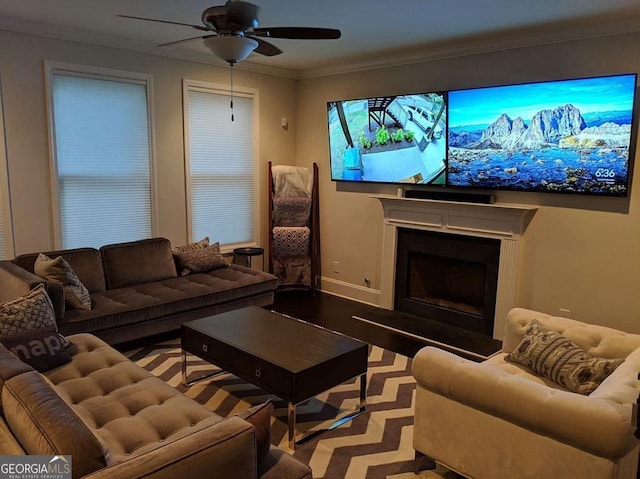 cinema room featuring ceiling fan and ornamental molding