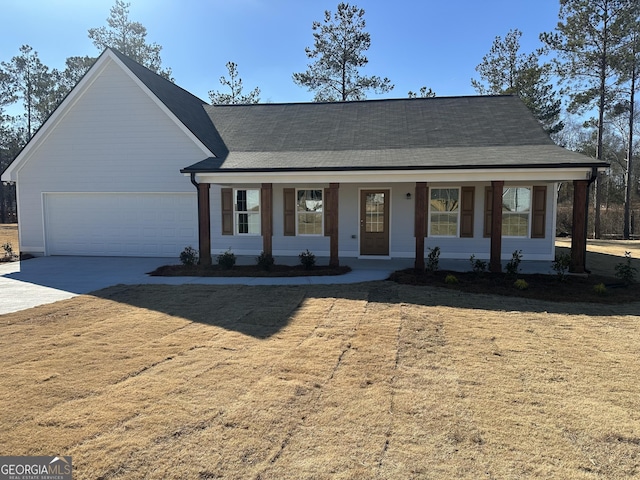 view of front of property featuring a porch, a garage, and a front yard