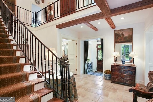 foyer entrance with coffered ceiling and beamed ceiling