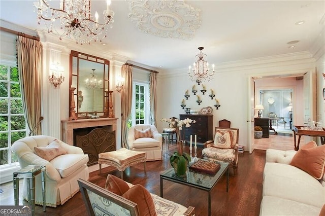 living area featuring crown molding, a notable chandelier, and hardwood / wood-style flooring