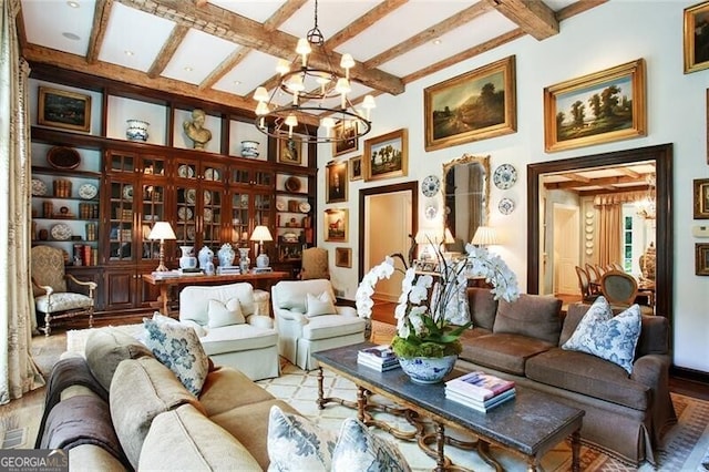 living area featuring an inviting chandelier, beamed ceiling, and light hardwood / wood-style floors