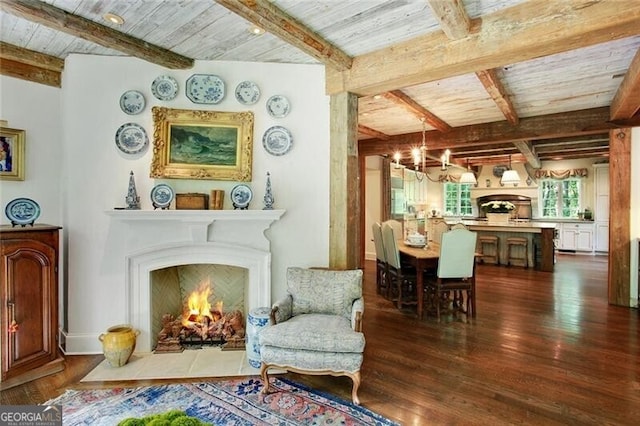 living area featuring wooden ceiling, dark wood-type flooring, beamed ceiling, and an inviting chandelier