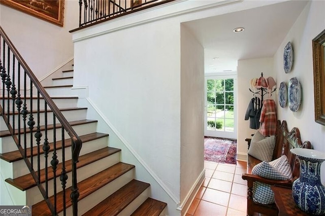 stairs featuring tile patterned flooring