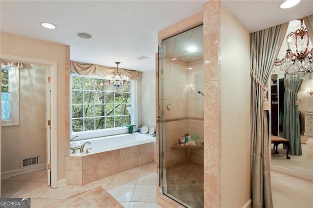 bathroom with separate shower and tub, an inviting chandelier, and tile patterned floors