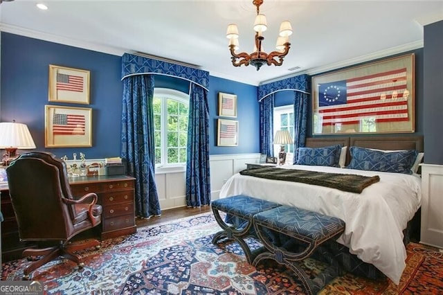 bedroom with ornamental molding, hardwood / wood-style flooring, and a notable chandelier