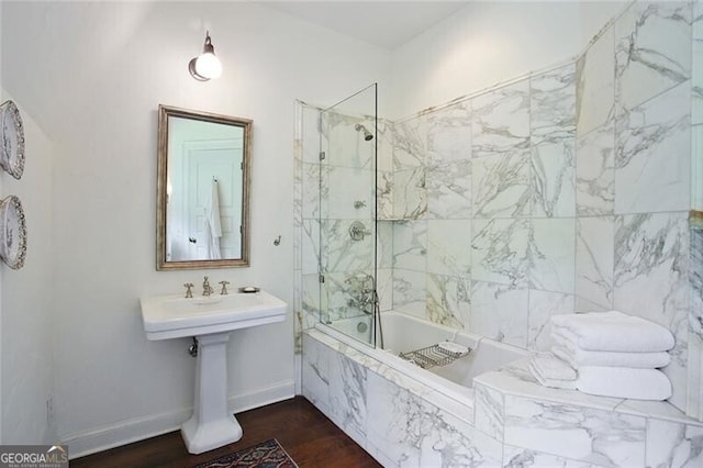 bathroom featuring tiled shower / bath combo and hardwood / wood-style flooring