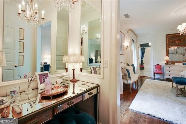 interior space with hardwood / wood-style floors, an inviting chandelier, and ornamental molding