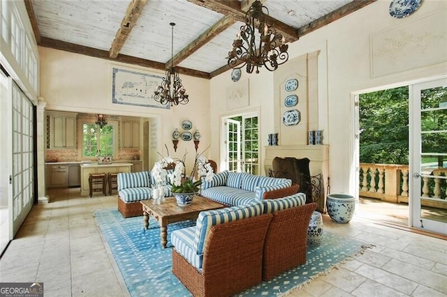 sunroom / solarium with wood ceiling, a wealth of natural light, an inviting chandelier, and vaulted ceiling with beams