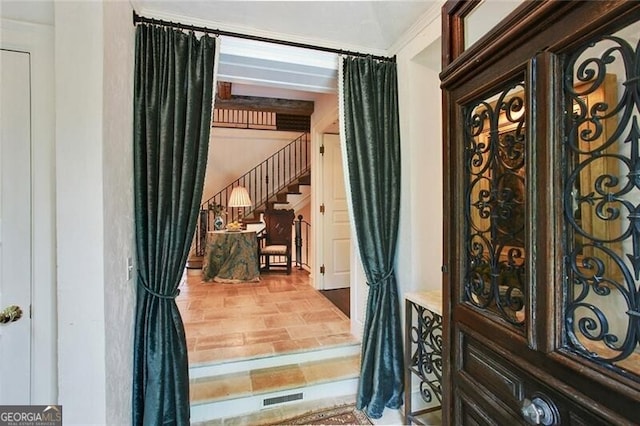 doorway featuring ornamental molding