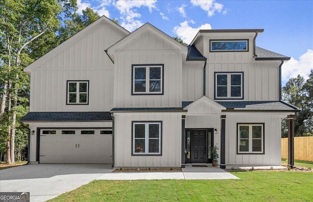 modern inspired farmhouse with a garage and a front yard