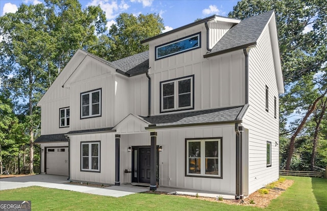 modern farmhouse style home with a front yard and a garage