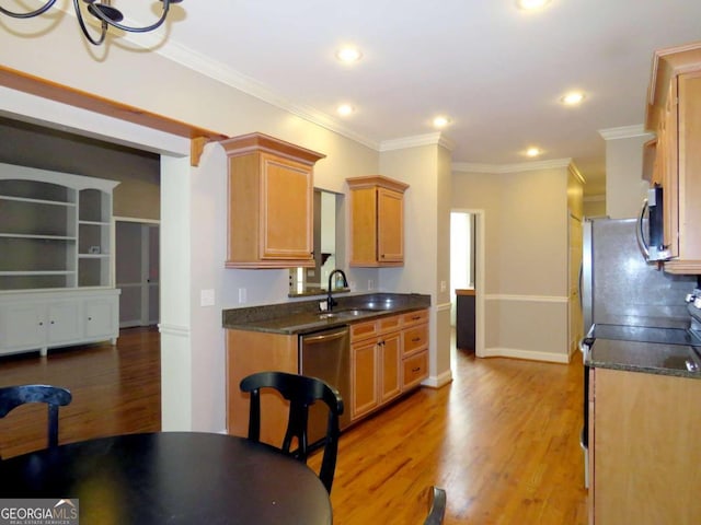 kitchen featuring light hardwood / wood-style floors, sink, ornamental molding, and stainless steel appliances