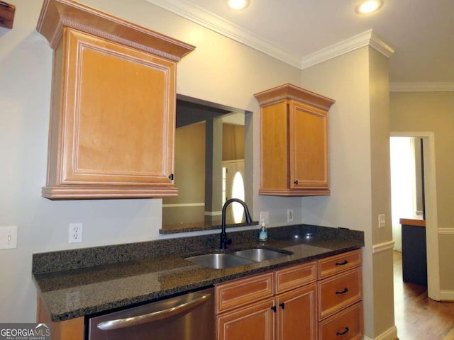 kitchen with crown molding, dishwasher, dark stone counters, and sink