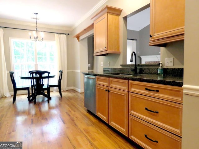 kitchen featuring dark stone counters, an inviting chandelier, sink, hanging light fixtures, and stainless steel dishwasher