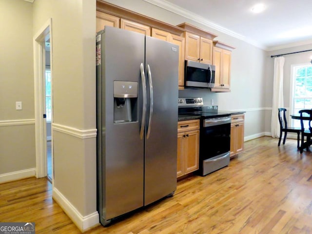 kitchen featuring light brown cabinetry, appliances with stainless steel finishes, crown molding, and light hardwood / wood-style floors