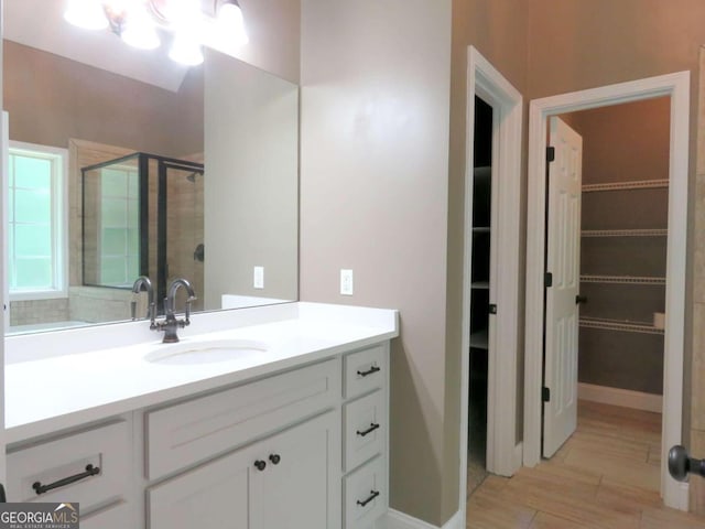 bathroom featuring an enclosed shower and vanity