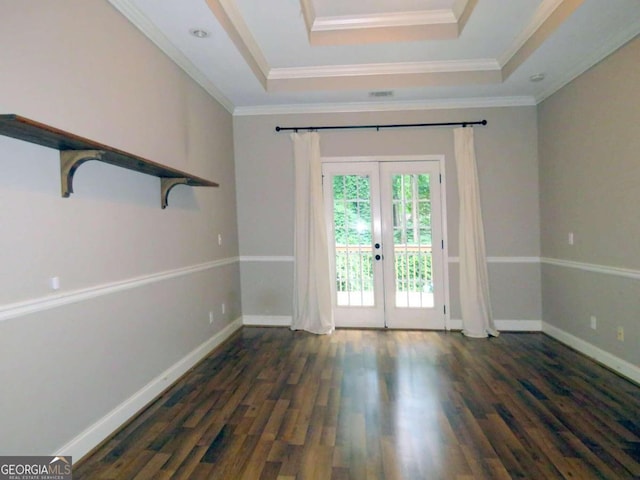 interior space featuring a raised ceiling, french doors, dark hardwood / wood-style flooring, and ornamental molding