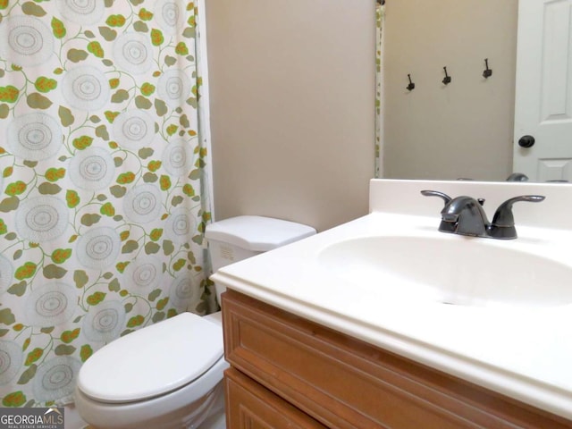 bathroom featuring toilet and vanity