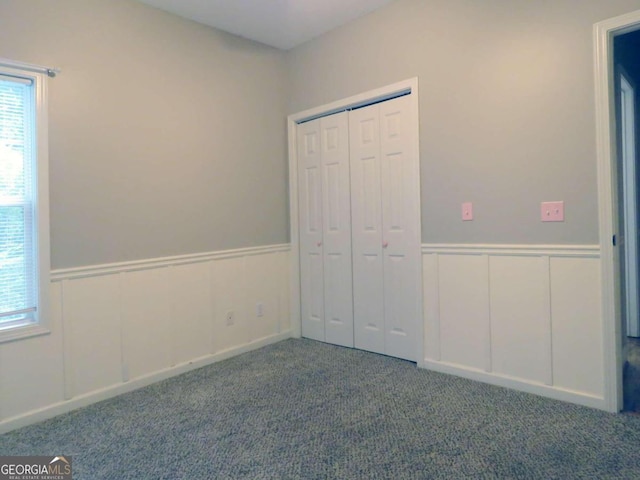 unfurnished bedroom with carpet floors and a closet