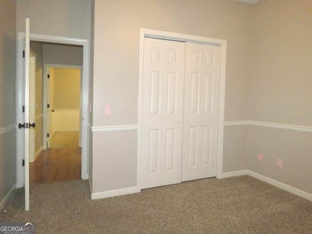 unfurnished bedroom featuring a closet and carpet