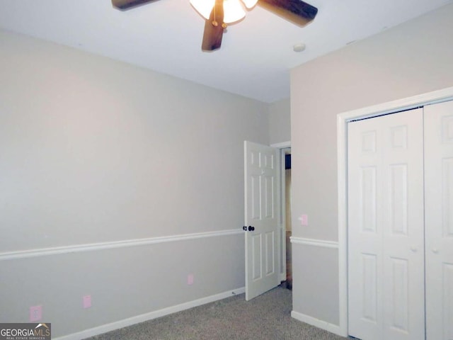 unfurnished bedroom featuring ceiling fan, a closet, and light carpet