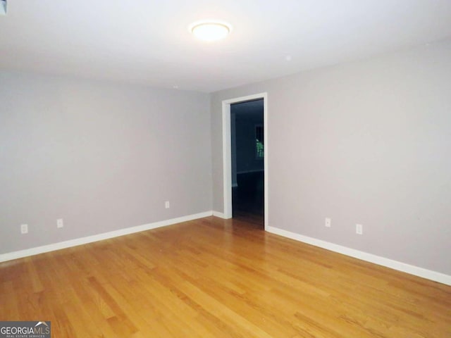 spare room with hardwood / wood-style flooring