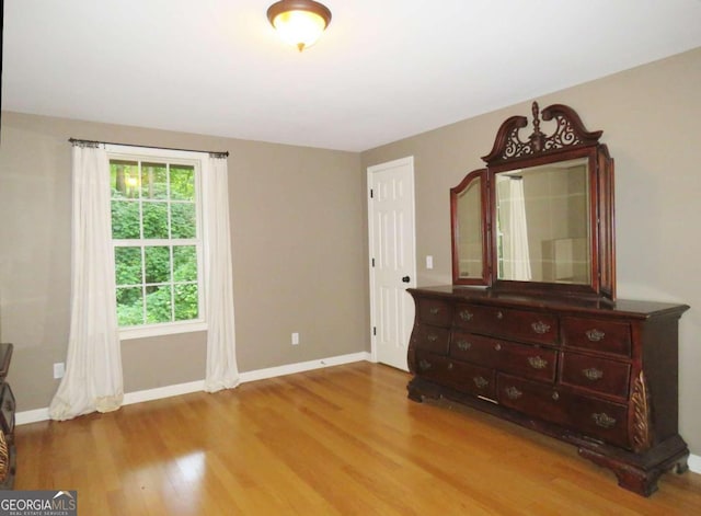 unfurnished bedroom with wood-type flooring