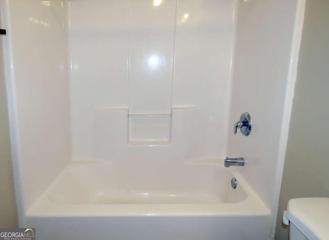 bathroom with toilet and shower / bathtub combination