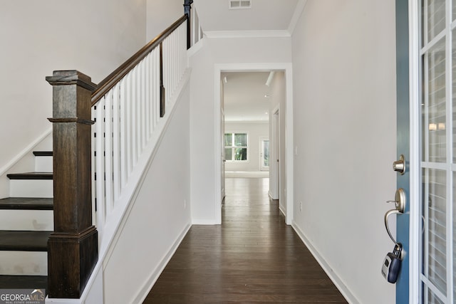 foyer entrance with dark hardwood / wood-style floors and crown molding