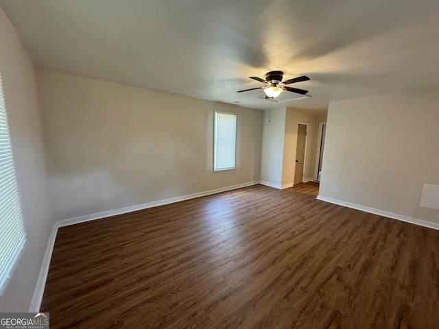 unfurnished room featuring dark wood-type flooring and ceiling fan