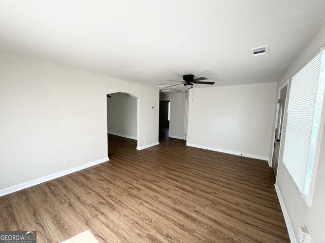 unfurnished room with ceiling fan and wood-type flooring