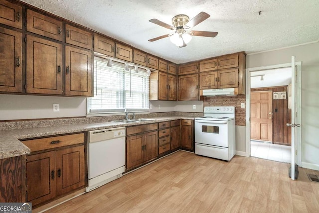 kitchen featuring light wood-type flooring, white appliances, a textured ceiling, and ceiling fan