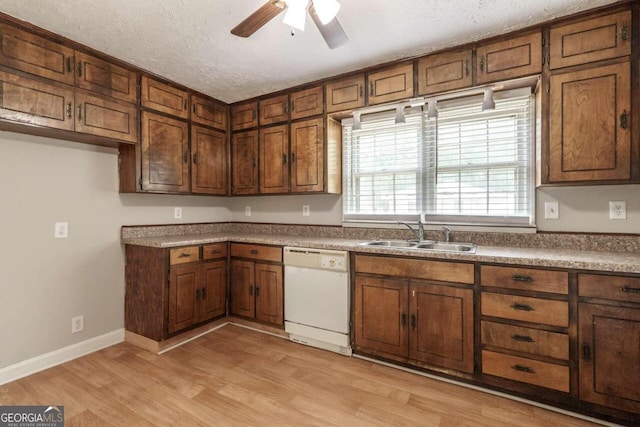 kitchen featuring a textured ceiling, light hardwood / wood-style flooring, dishwasher, sink, and ceiling fan