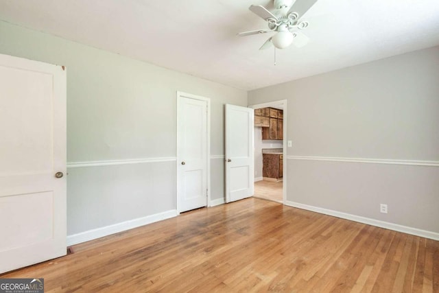 unfurnished bedroom featuring ceiling fan and hardwood / wood-style flooring