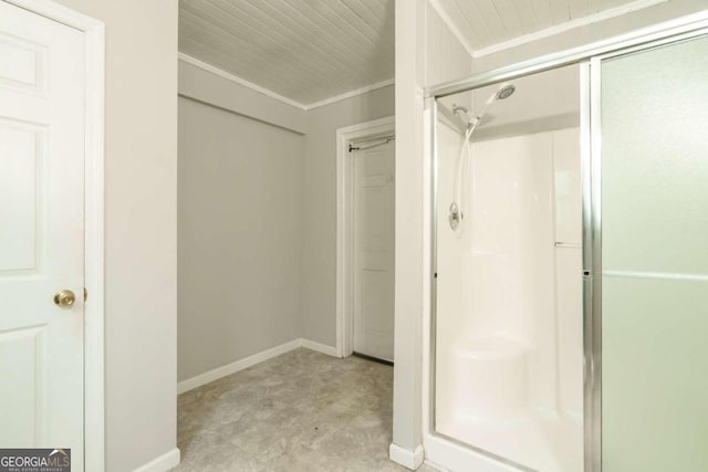 bathroom featuring crown molding and a shower with door