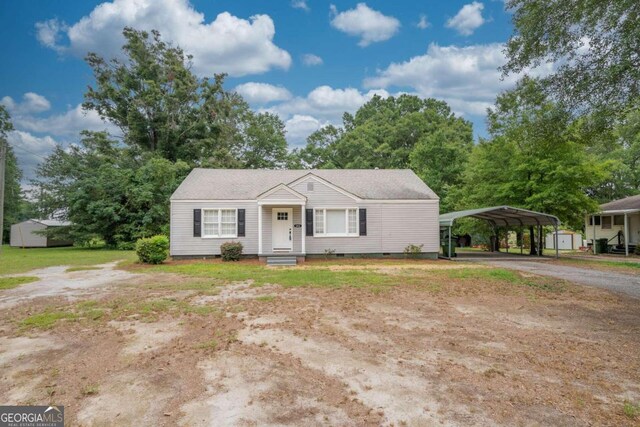 view of front of property with a carport