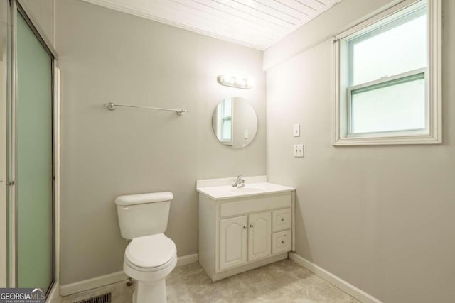 bathroom featuring vanity, toilet, and a shower with door