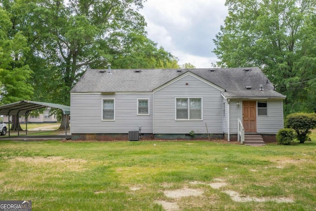 back of house featuring a yard, central AC unit, and a carport