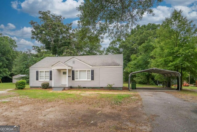 view of front of home with a carport