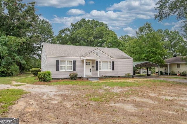 view of front of property featuring a carport