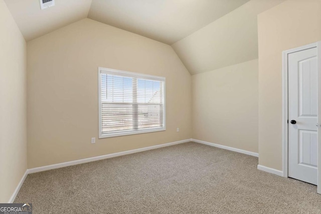 bonus room featuring lofted ceiling, baseboards, and light colored carpet