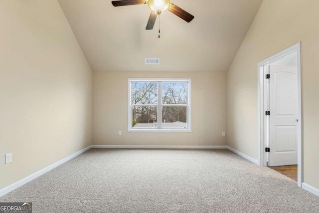 additional living space with baseboards, visible vents, vaulted ceiling, and carpet flooring