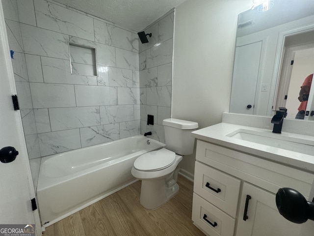 full bath featuring bathing tub / shower combination, visible vents, toilet, vanity, and wood finished floors