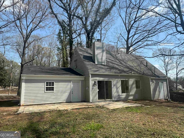 rear view of property featuring a yard and a patio