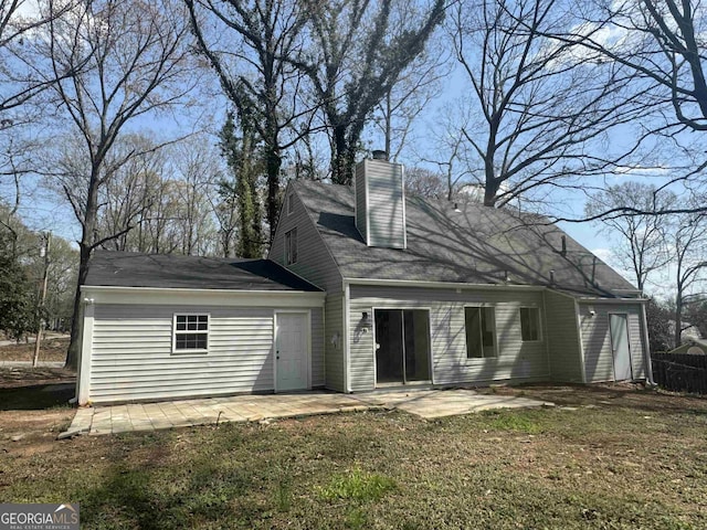 view of front of home featuring a patio and a chimney