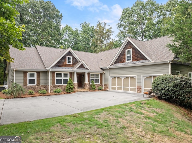 craftsman-style home featuring a garage and a front lawn