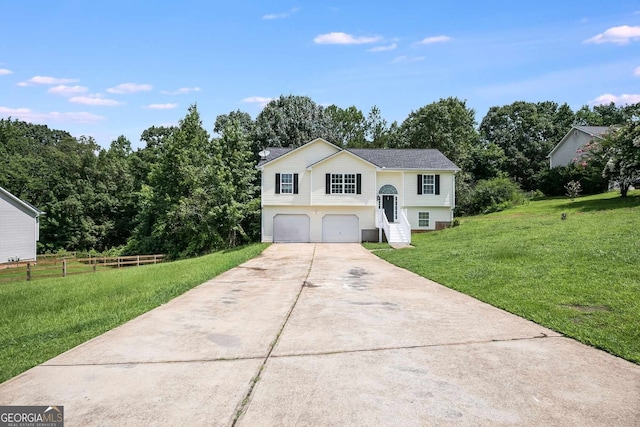 split foyer home with a garage and a front lawn